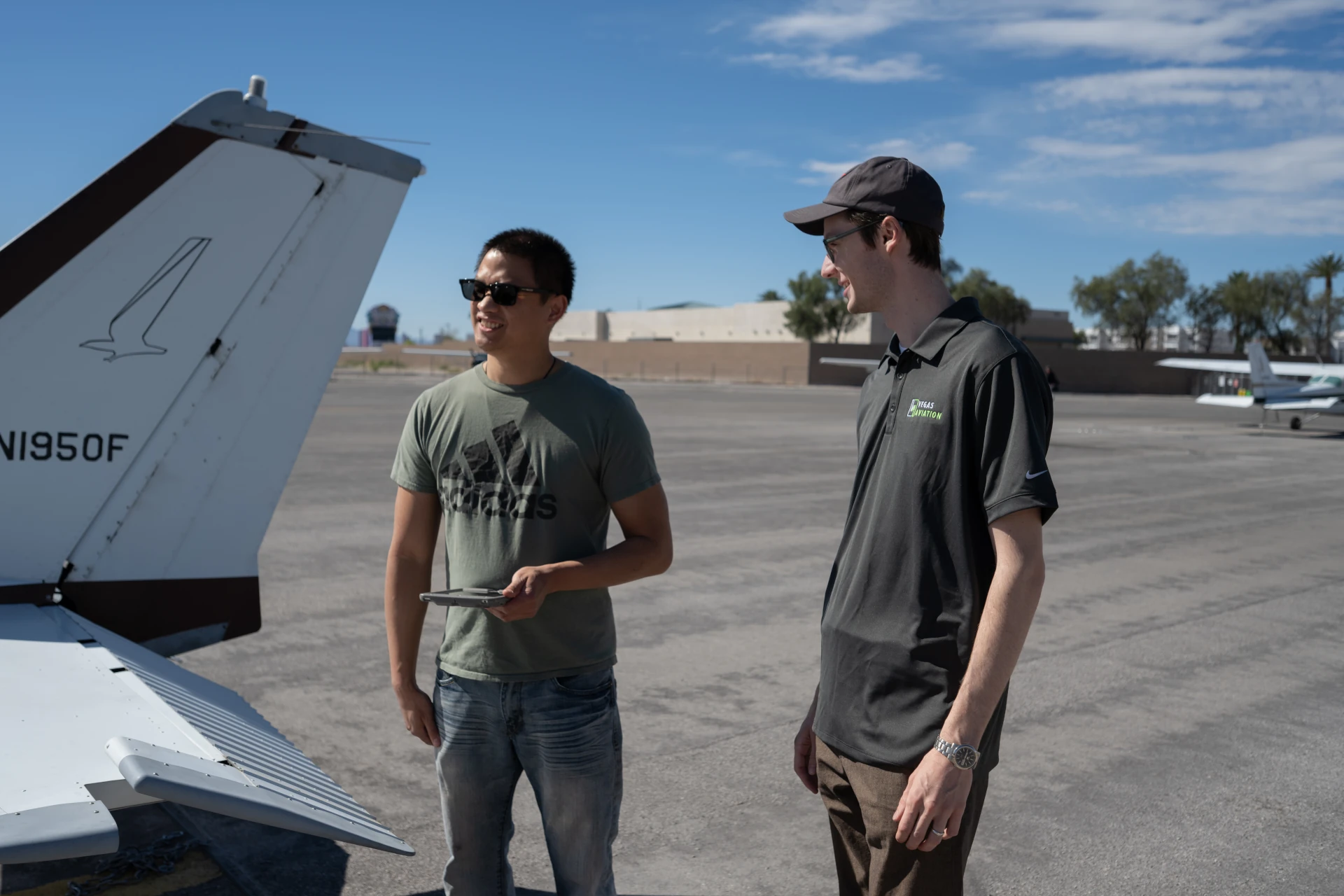 Vegas Aviation student and flight instructor standing beside a training aircraft